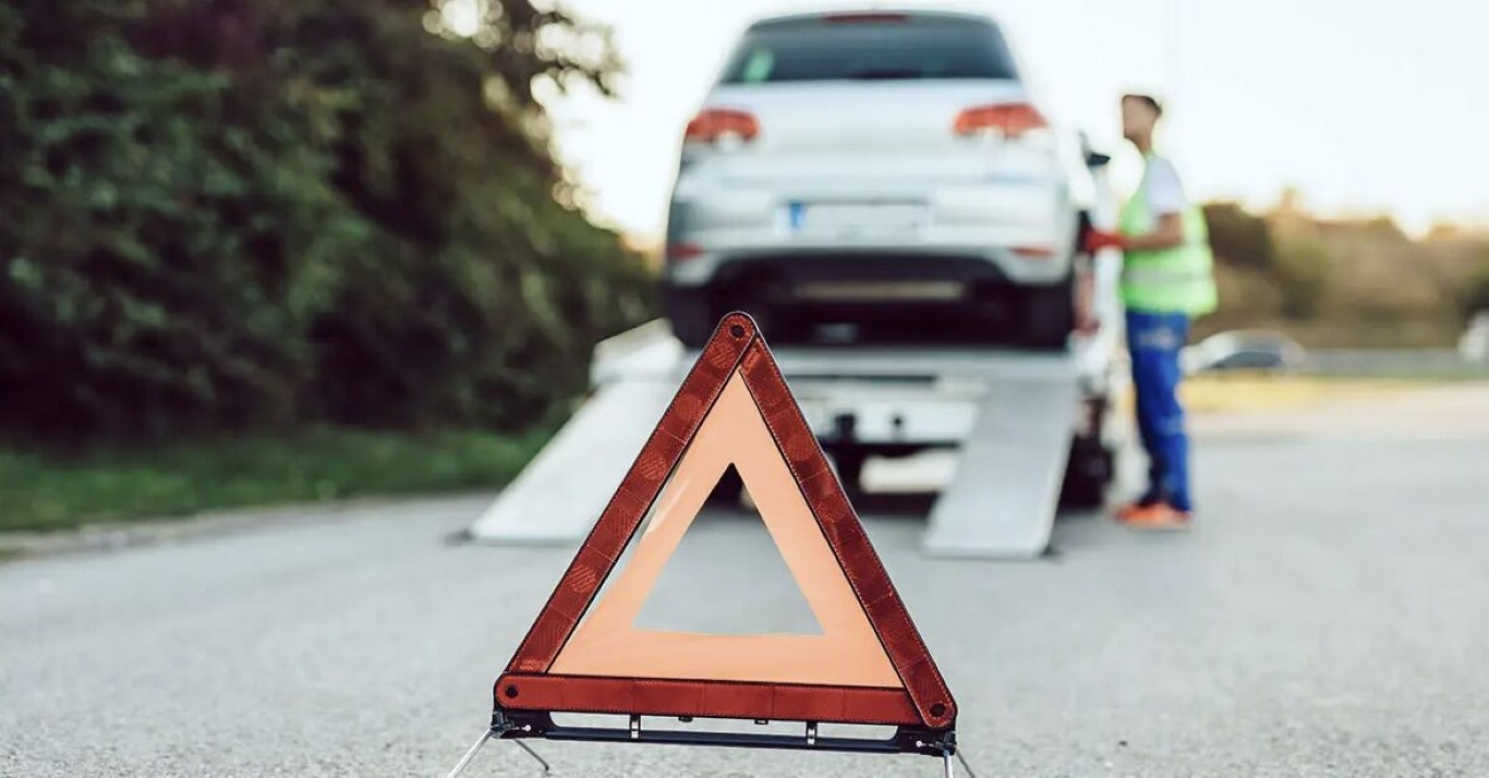 Emergency roadside towing with warning triangle and professional assistance